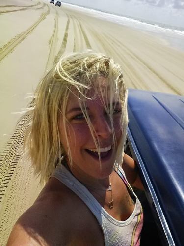 a girl driving off road in Fraser Island, Australia
