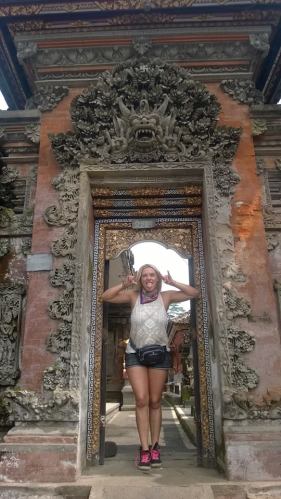 girl standing in ornate temple doorway in Bali