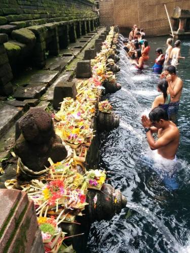 People bathing in the holy spring water of Titra Empul