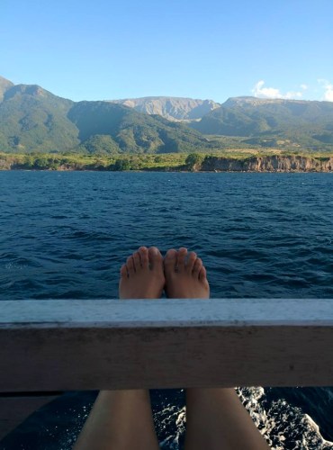 bare feet in front of the ocean