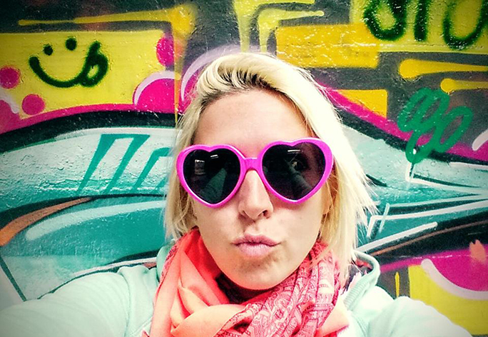 Graffiti wall close up of girl making a kiss face