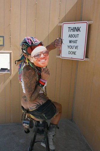 Girl sitting in a reflection booth at Burning Man