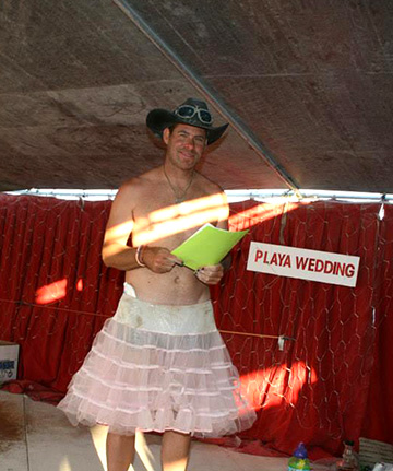 Our playa priest wearing a cowboy hat and a tutu