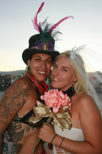 two brides pose for wedding portraits after their burning man wedding