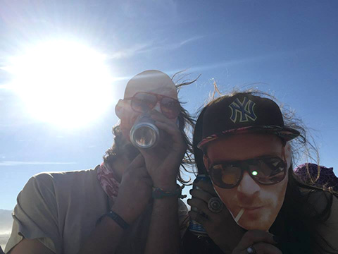 Friends playing with a cardboard cutout of another friends face