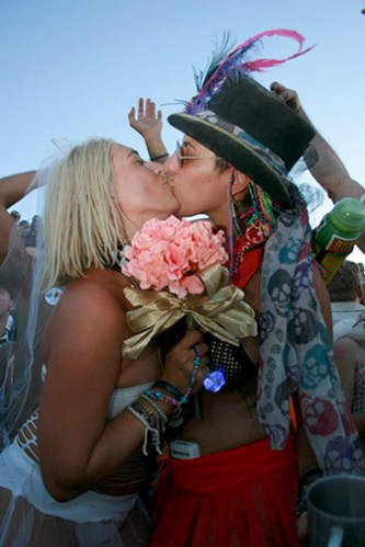 Two brides kiss after marrying at burning man
