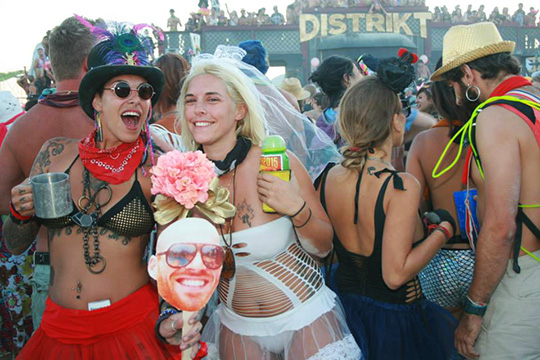 A happy newly wed couple celebrates at burning man