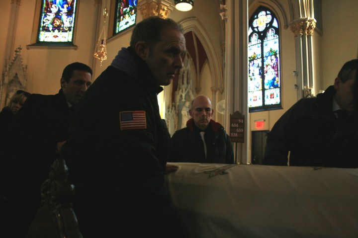 family carrying out the casket of a beloved father